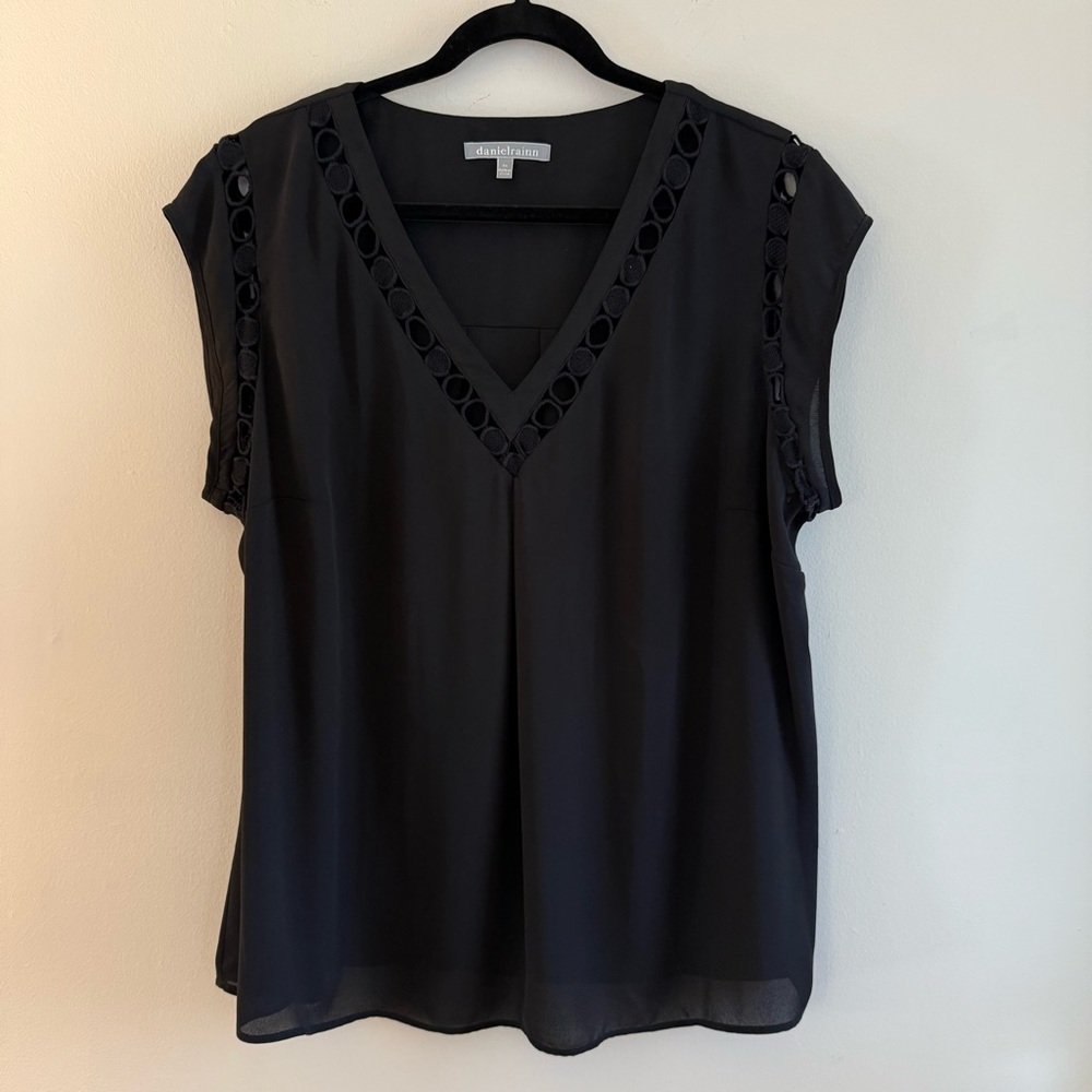 Black blouse with cut out details.  Size 2X.  Looks great untucked or tucked.